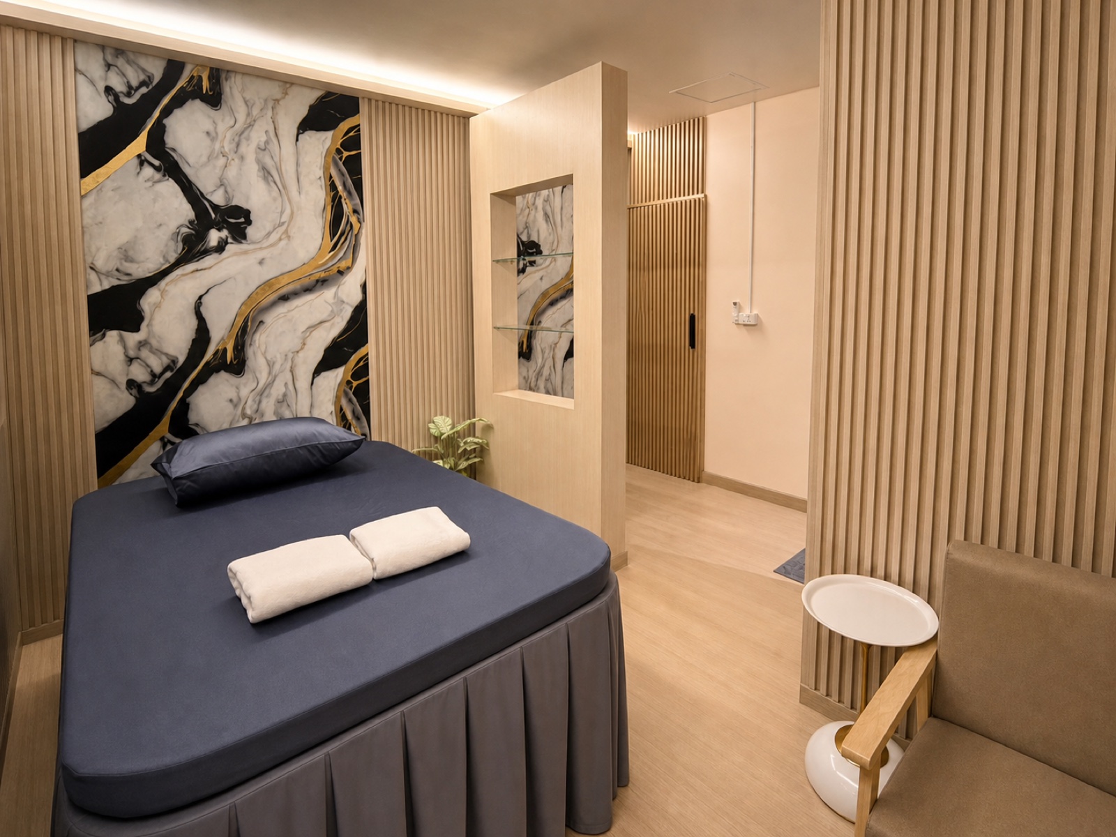 ภาพจริงห้องส่วนตัว QQ SPA พร้อมเตียงนวด ผนังไม้โอ๊กสีอ่อน และผนังลายหินอ่อน